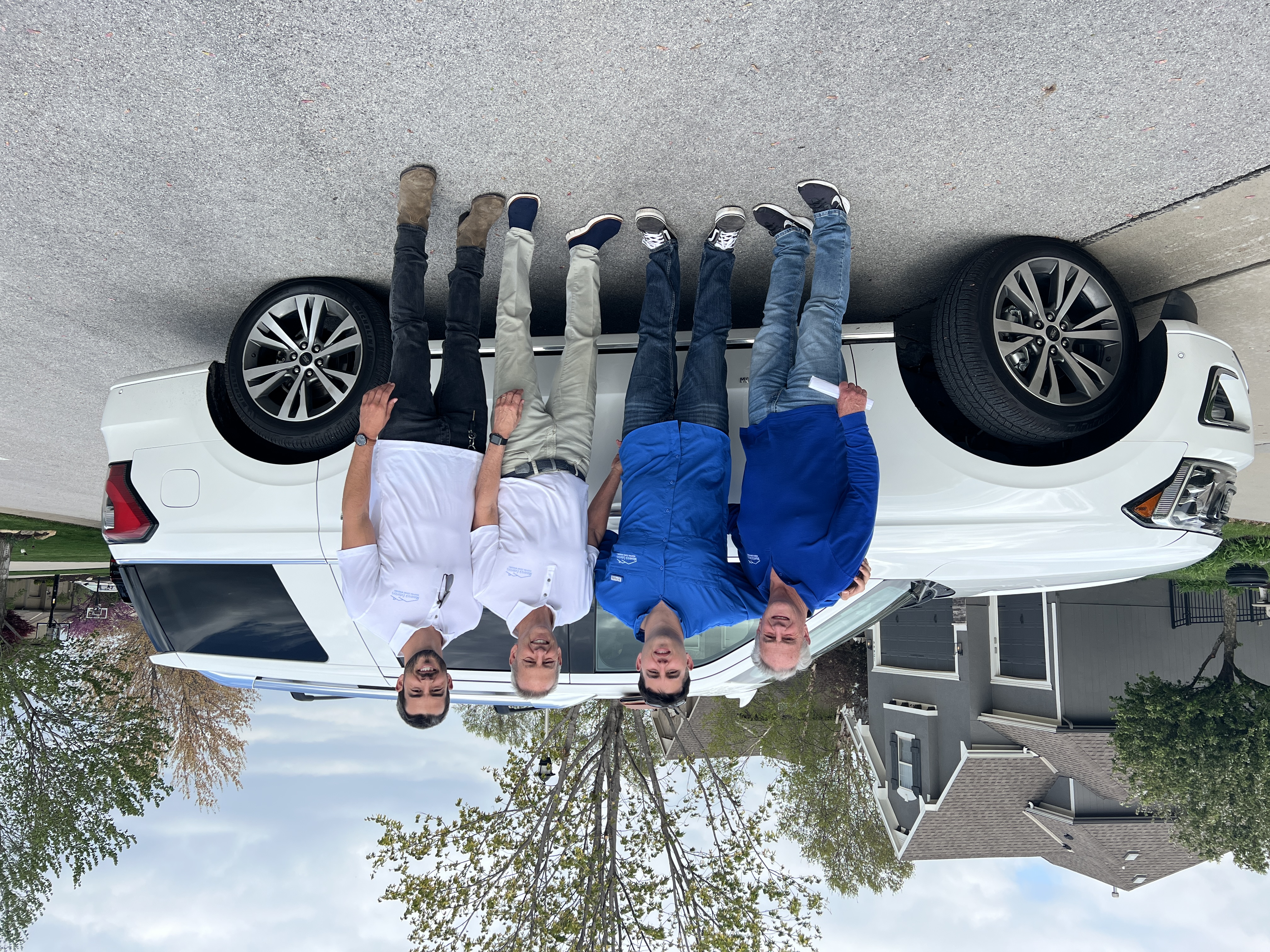 Maverick Exteriors team standing by a company vehicle
